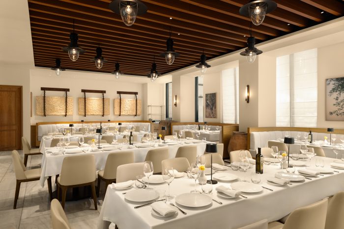 Aegan Priving Dining Room at Estiatorio Milos toronto with rows of tables and banquettes with seating for 40