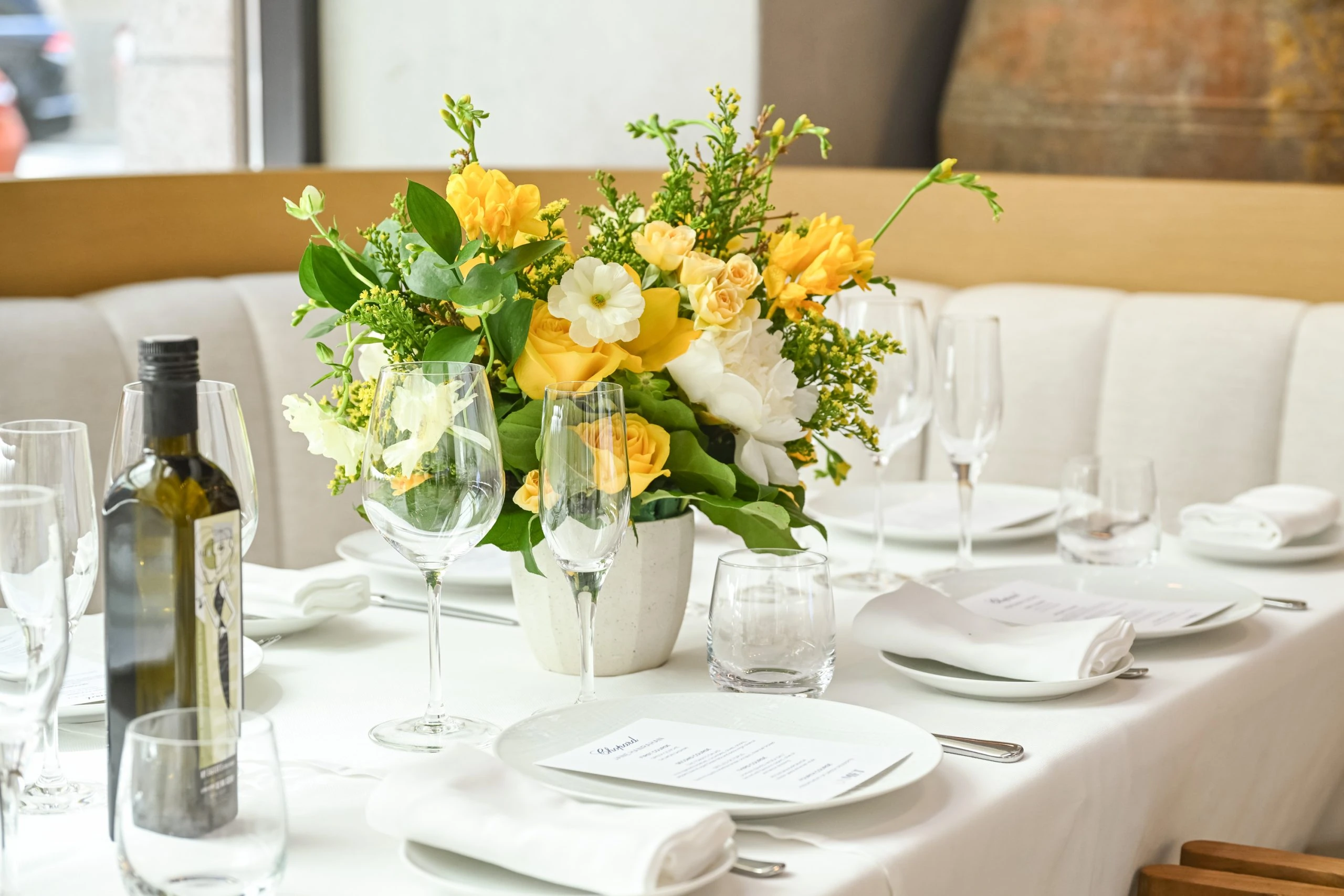 Milos Toronto private event with a spring flower bouquet presented on a set table